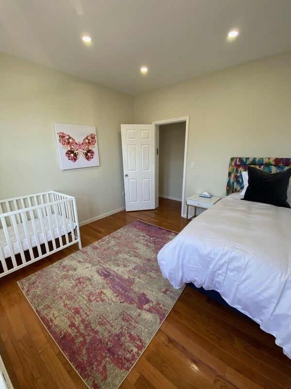 Bedroom with a bed and a crib for young children