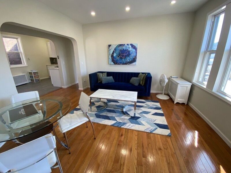 Bright living room with hardwood floors and large windows