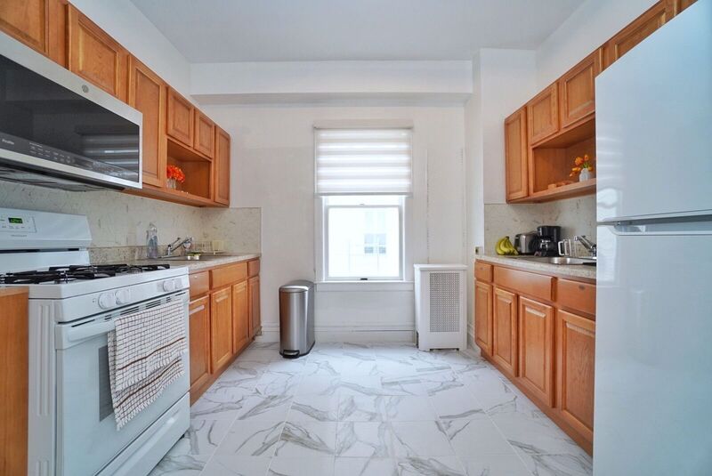 Full kosher kitchen with oven, refrigerator and counter space